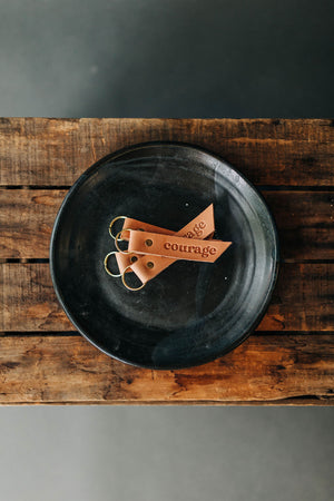 the design: courage. the material: leather.hand stamped by lost penguin leather, made in texas. key fobs are fun but leather key fobs are the most fun. Ramble & Co. is a family owned business. Shop at shop.rambleandcompany.com or visit our store in Wichita Falls, Texas || small batch/ hand printed tees + fine art prints | your source of encouragement + inspiration.