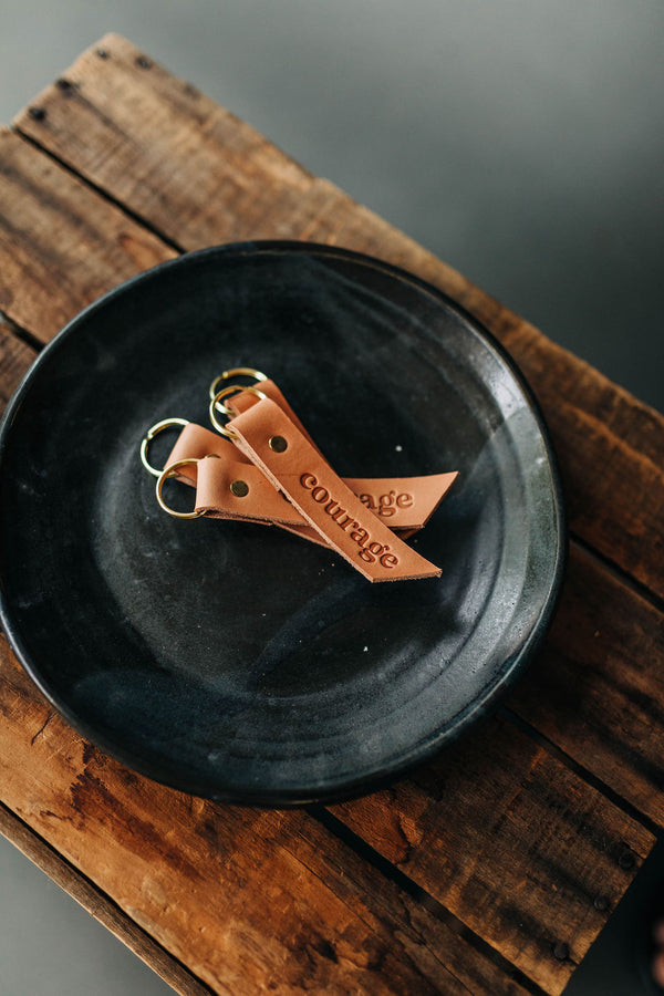 the design: courage. the material: leather.hand stamped by lost penguin leather, made in texas. key fobs are fun but leather key fobs are the most fun. Ramble & Co. is a family owned business. Shop at shop.rambleandcompany.com or visit our store in Wichita Falls, Texas || small batch/ hand printed tees + fine art prints | your source of encouragement + inspiration.