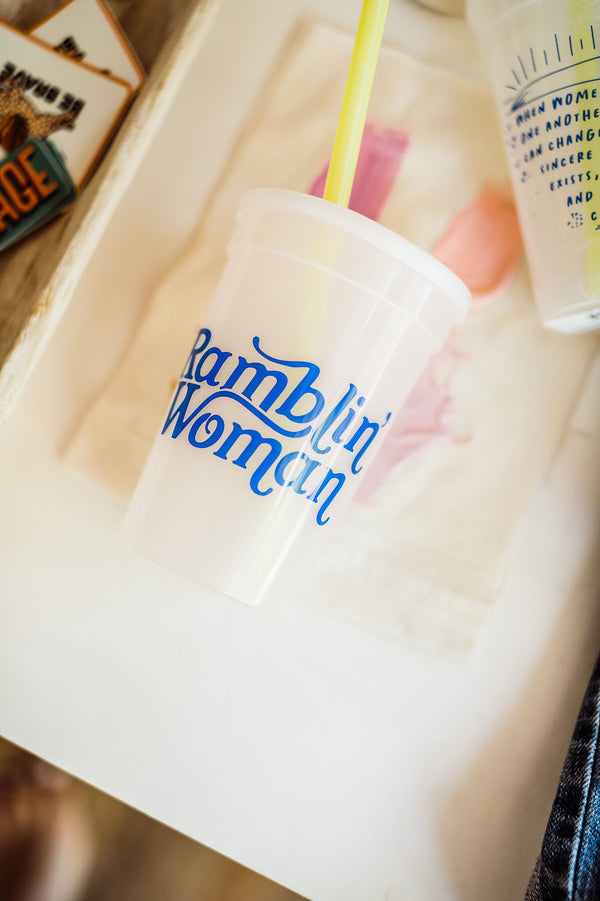 17 oz  clear, color changing cup with ramblin woman text in blue | includes straw + lid set || you can shop now at  shop.rambleandcompany.com or visit our storefront in downtown Wichita Falls, Texas || small batch + hand printed tees | home goods | paper goods | gifts + more
