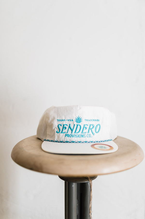 sendero logo | white + aqua hat