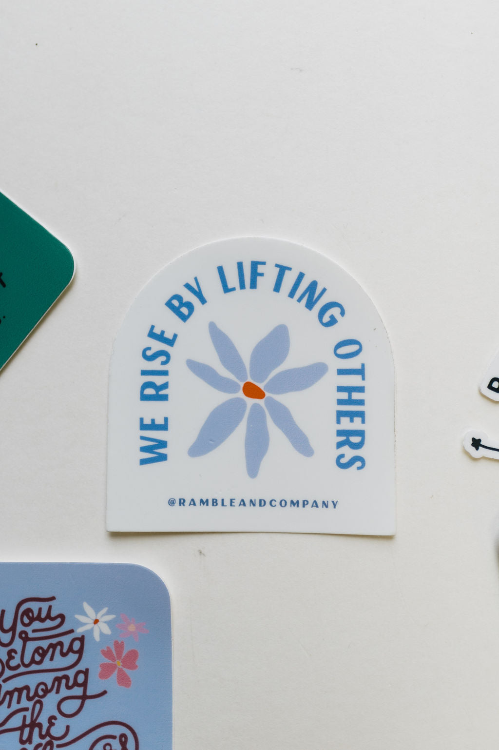 we rise by lifting others | sticker