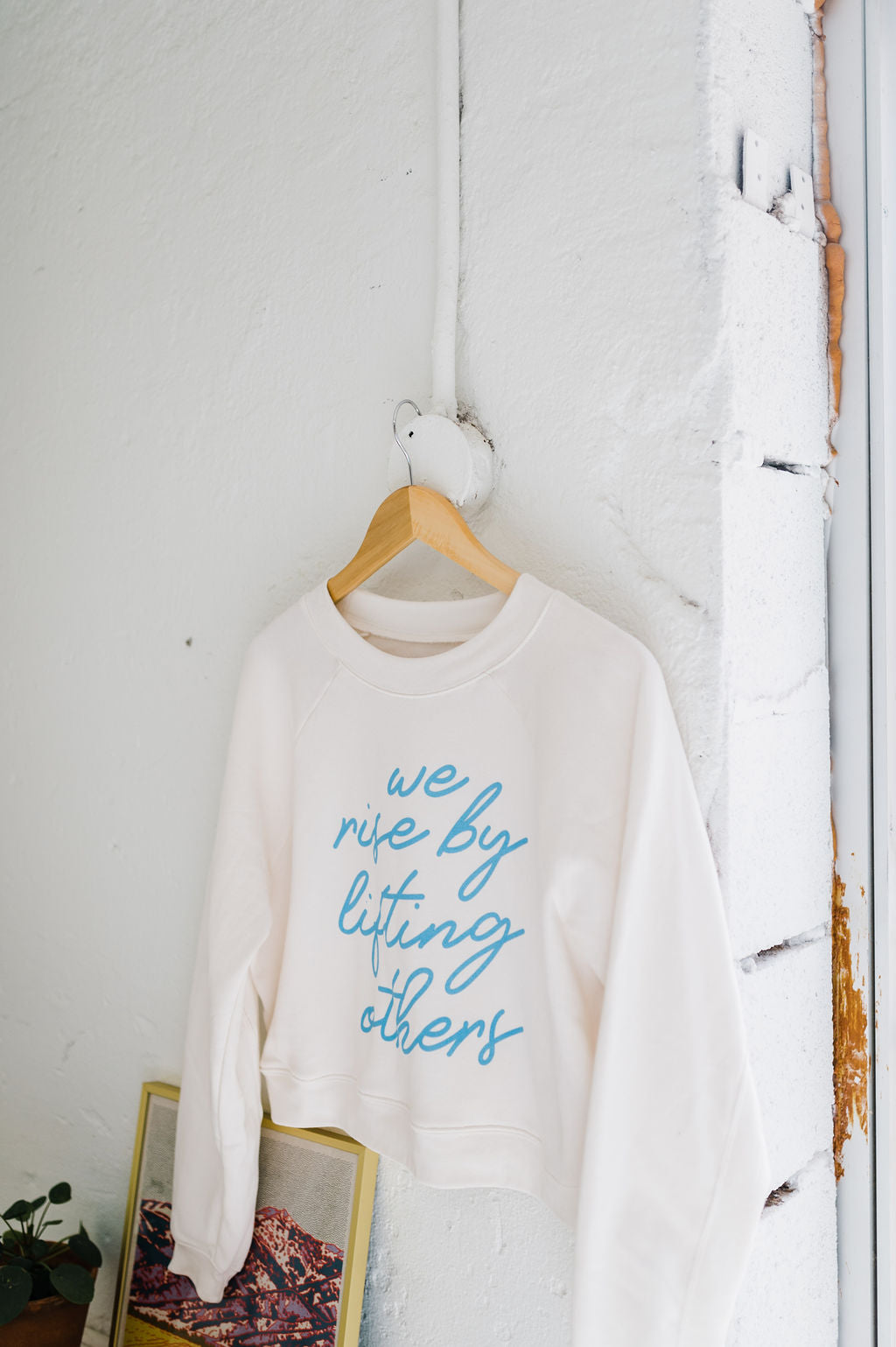 we rise by lifting others | crop raglan fleece sweatshirt cream
