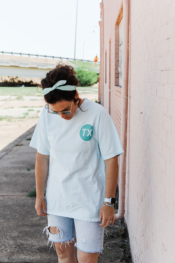 design: ﻿TX front left and LONE STAR STATE back  color: light blue + sea foam ink. 100% ringspun cotton garment dyed may shrink slightly after wash. style: Classic unisex style, runs true to size. This a thicker old school, unisex tee. The perfect summer go-to.  Kathryn is 5&#39;4 wearing a medium. Ramble &amp; Co. is a family owned business. Shop at shop.rambleandcompany.com or visit our store in Wichita Falls, Texas || small batch/ hand printed tees + fine art prints | your source of encouragement + inspiration.