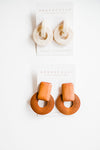 Warm wood colored earrings made out of wood. Handmade in Texas and lightweight with dimensions of 5.5cm by 3.9cm. Eye catching neutral colored earrings that will have everyone asking you where you got them! Ramble & Co. is a family owned business. Shop at shop.rambleandcompany.com or visit our store in Wichita Falls, Texas || small batch/ hand printed tees + fine art prints | your source of encouragement + inspiration.
