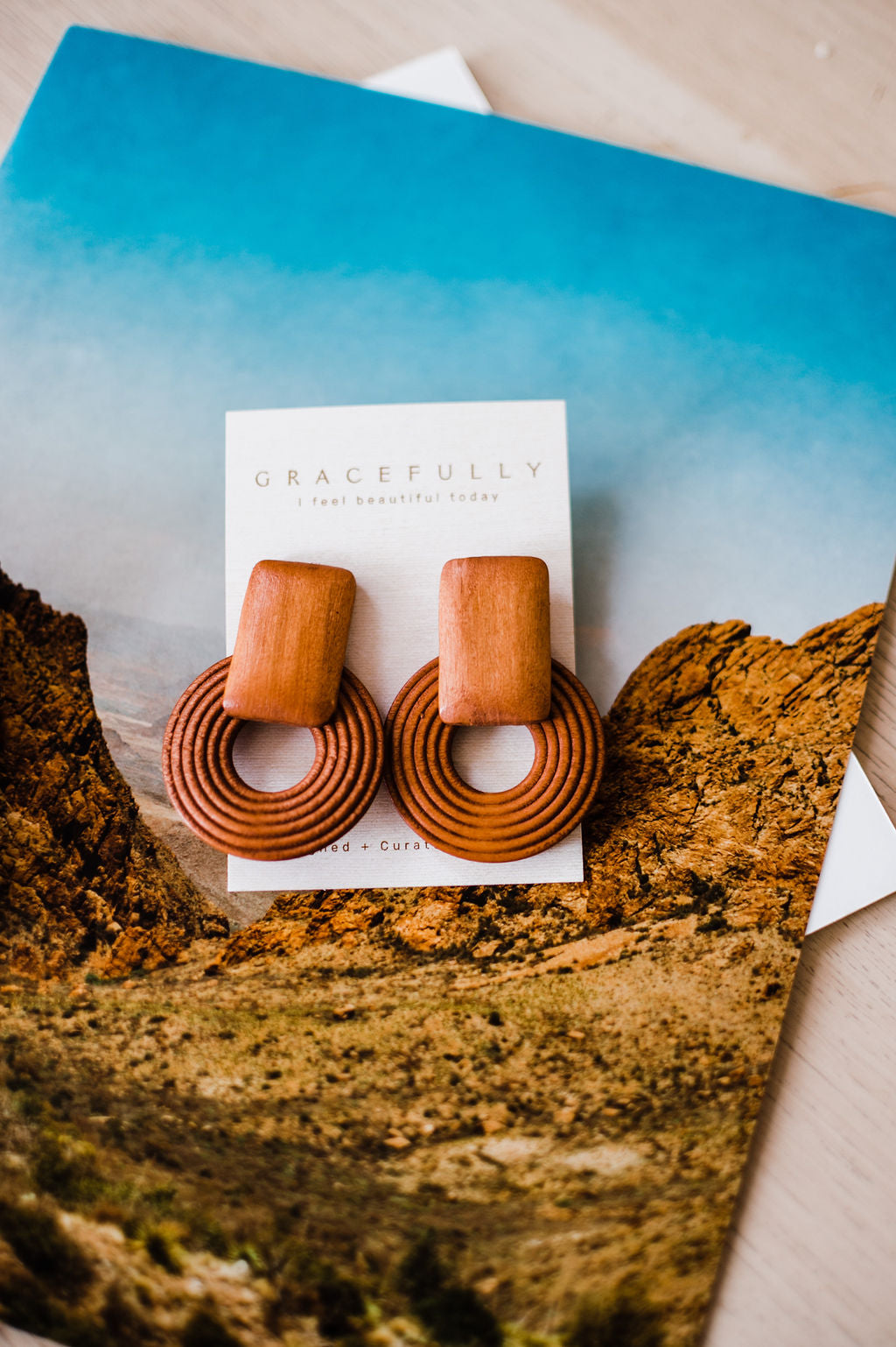 Warm wood colored earrings made out of wood. Handmade in Texas and lightweight with dimensions of 5.5cm by 3.9cm. Eye catching neutral colored earrings that will have everyone asking you where you got them! Ramble & Co. is a family owned business. Shop at shop.rambleandcompany.com or visit our store in Wichita Falls, Texas || small batch/ hand printed tees + fine art prints | your source of encouragement + inspiration.