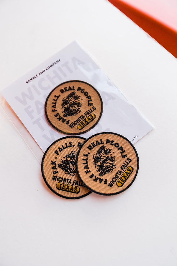 So many possibilities + ways to use these Ramble &amp; Co. patches. the design: fake falls, real people. tan, black, and gold approx. 2.5&quot; x 2.5&quot; To apply: Each patch is woven with an iron on backing. Ramble &amp; Co. is a family owned business. Shop at shop.rambleandcompany.com or visit our store in Wichita Falls, Texas || small batch/ hand printed tees + fine art prints | your source of encouragement + inspiration.
