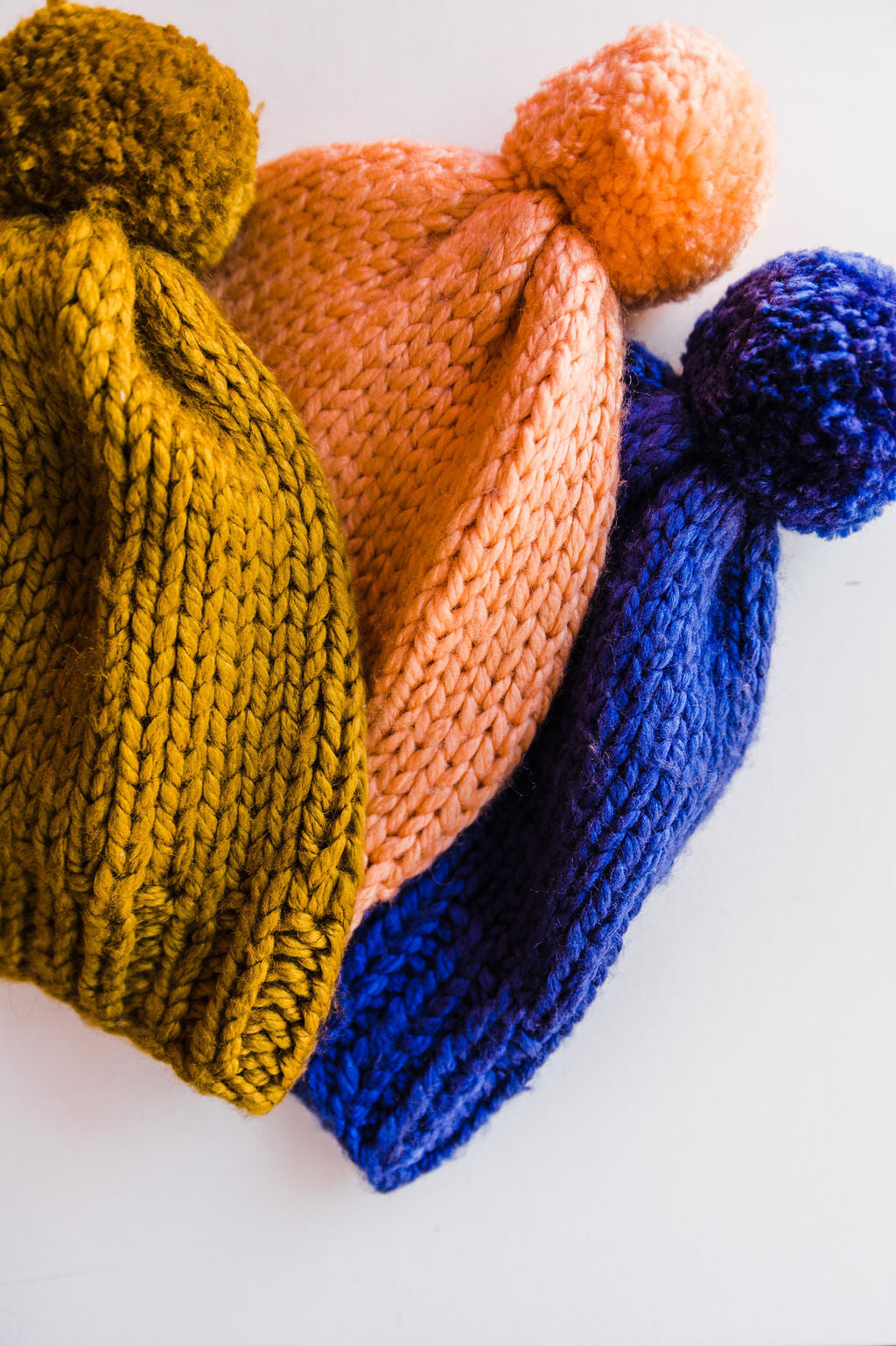 The Design: Our hand-knitted beanie is made of a wool blend, and is thick and cozy! With colors in spice, cobalt, and peach even the grayest day will have a pop of happy. Made in India 80% acrylic 20% wool Hand knit with hand made Pom Pom Care: Wash on gentle cycle. Lay flat to dry. Ramble & Co. is a family owned business. Shop at shop.rambleandcompany.com or visit our store in Wichita Falls, Texas || small batch/ hand printed tees + fine art prints | your source of encouragement + inspiration.