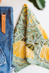 Light green bandana with yellow flowers design by Hemlock Goods | you can shop now at  shop.rambleandcompany.com or visit our storefront in downtown Wichita Falls, Texas || small batch + hand printed tees | home goods | paper goods | gifts + more