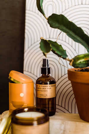 7.75 fl oz room & linen spray made with a blend of body-safe fine fragrance oils and water in an amber glass bottle | scent is a blend of  leather, teak, and orange. | made by PF Candle Co. || you can shop now at shop.rambleandcompany.com or visit our storefront in downtown Wichita Falls, Texas || small batch + hand printed tees | home goods | paper goods | gifts + more