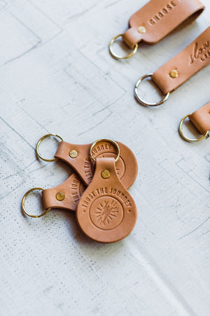 the design: trust the journey. the material: leather. hand stamped by lost penguin leather, made in texas. key fobs are fun but leather key fobs are the most fun. Ramble & Co. is a family owned business. Shop at shop.rambleandcompany.com or visit our store in Wichita Falls, Texas || small batch/ hand printed tees + fine art prints | your source of encouragement + inspiration.